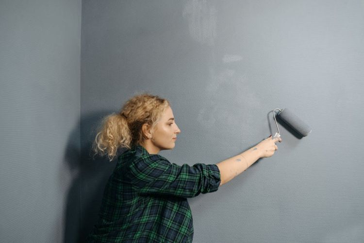 woman painting wall